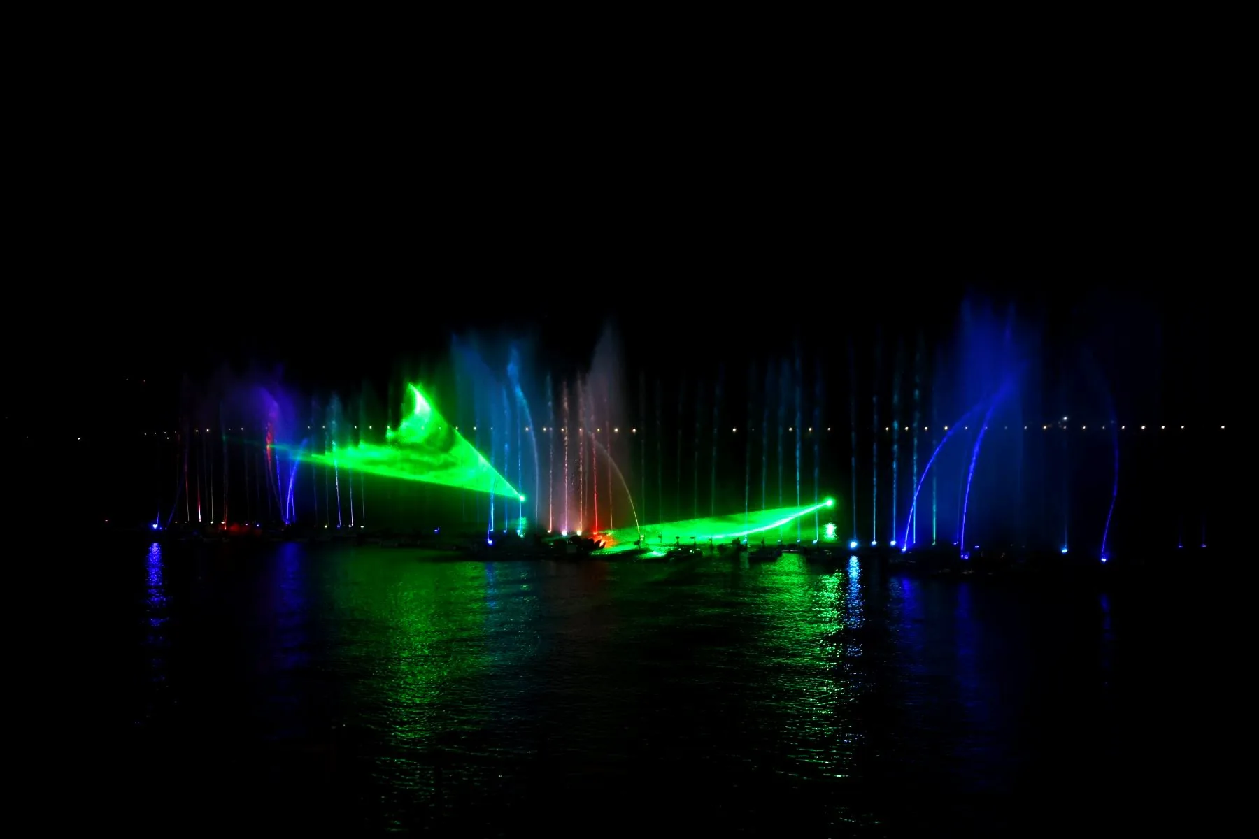 RGB laser pass over a fountain at night